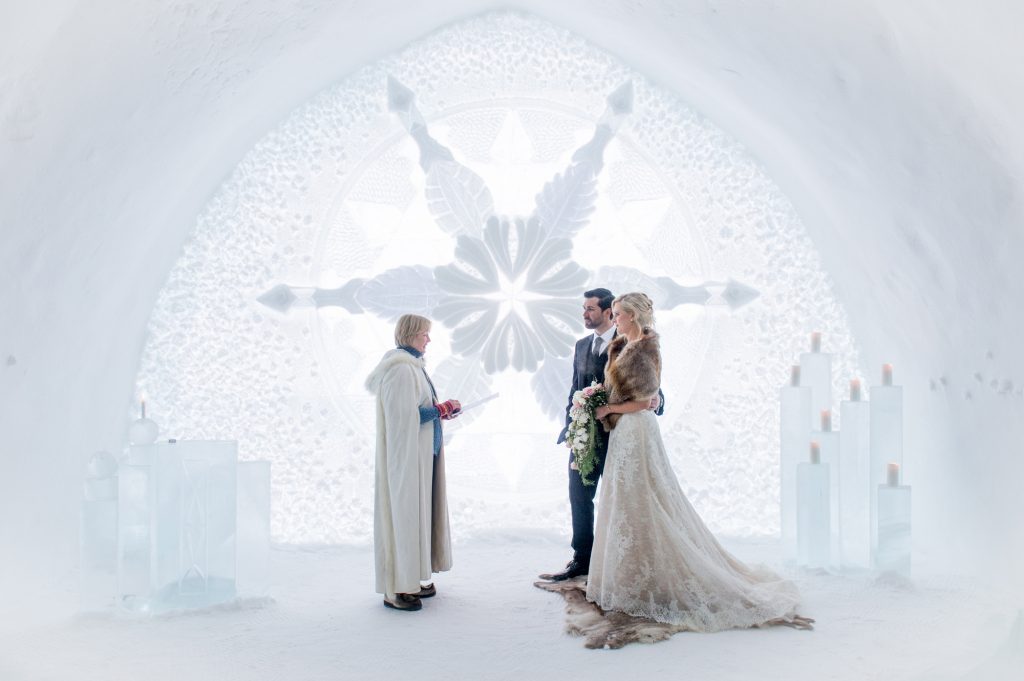 Couple getting married in an ice church