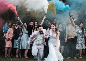 Wedding couple running away from wedding colours