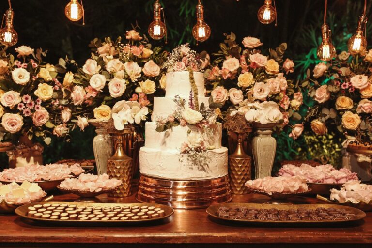 Wedding guests bring their own food — dessert table with wedding cake and flowers